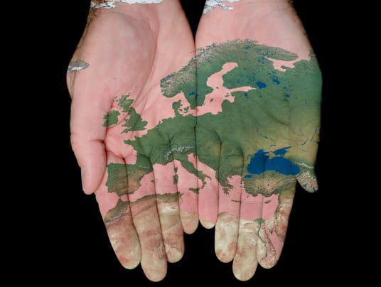 Map Of Europe Painted On Hands Showing Concept Of Europe In Our Hands